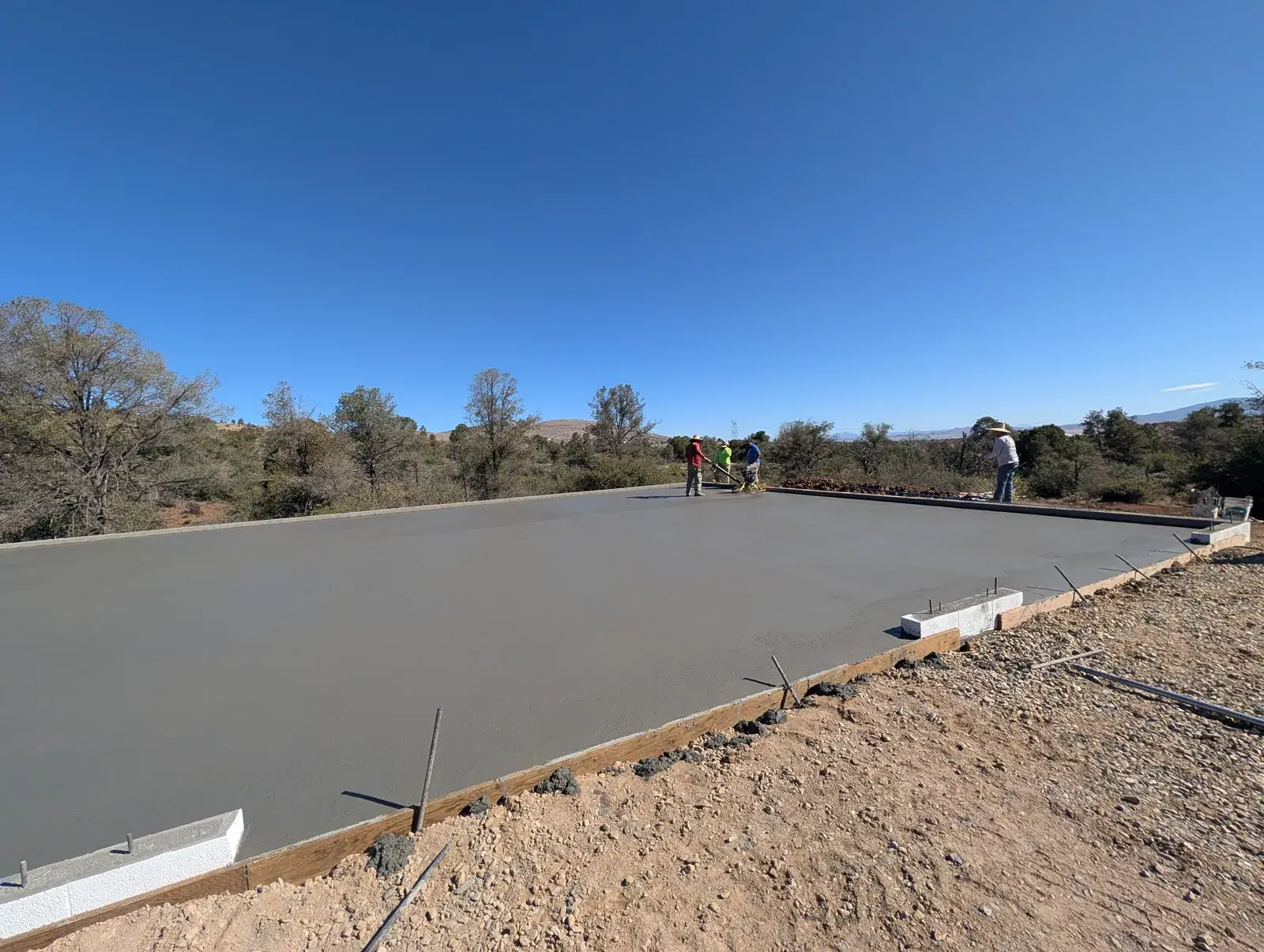 Finished concrete foundation slab on a Northern Arizona building lot