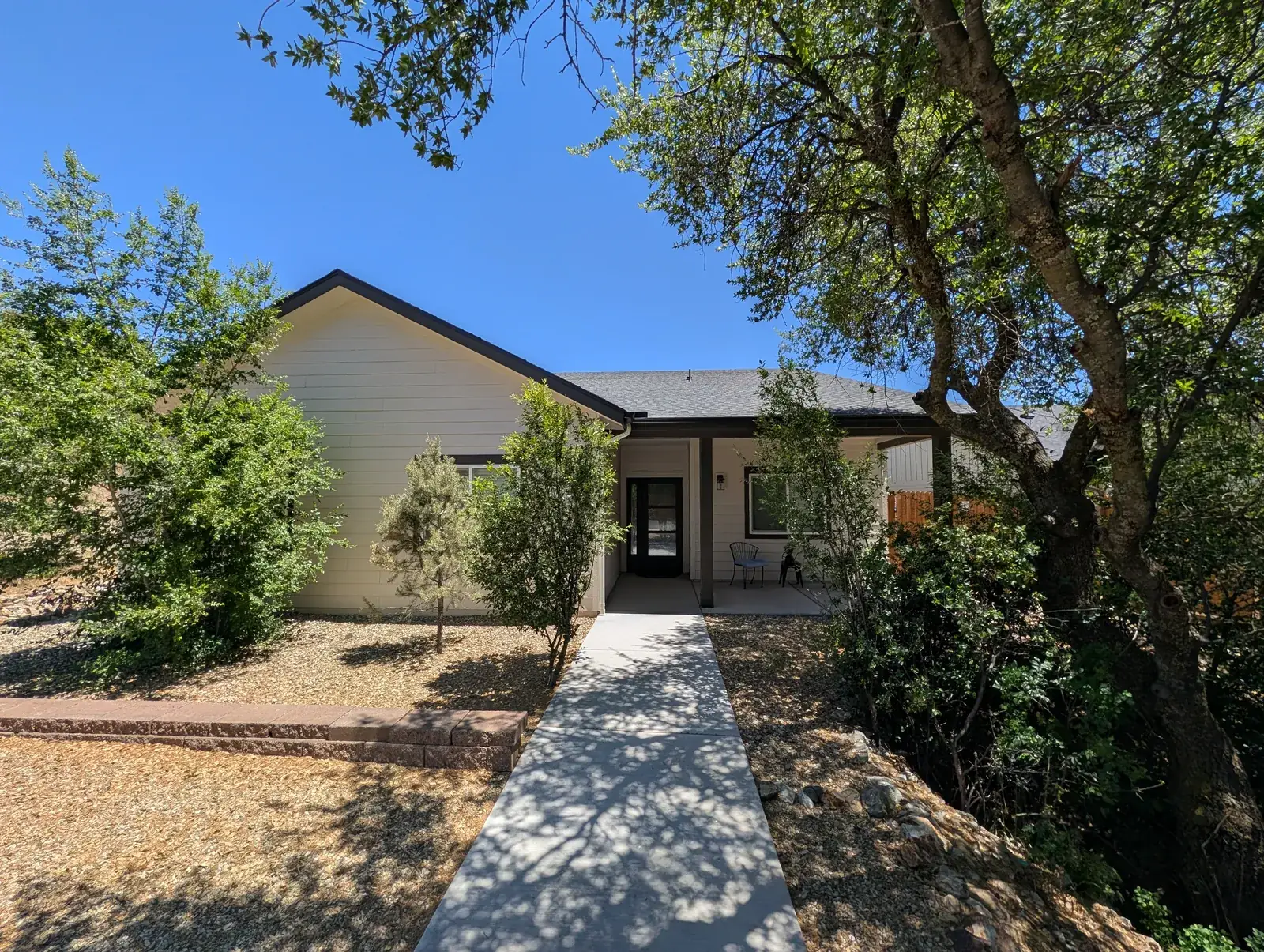 Finished custom home exterior with landscaped walkway in Northern Arizona