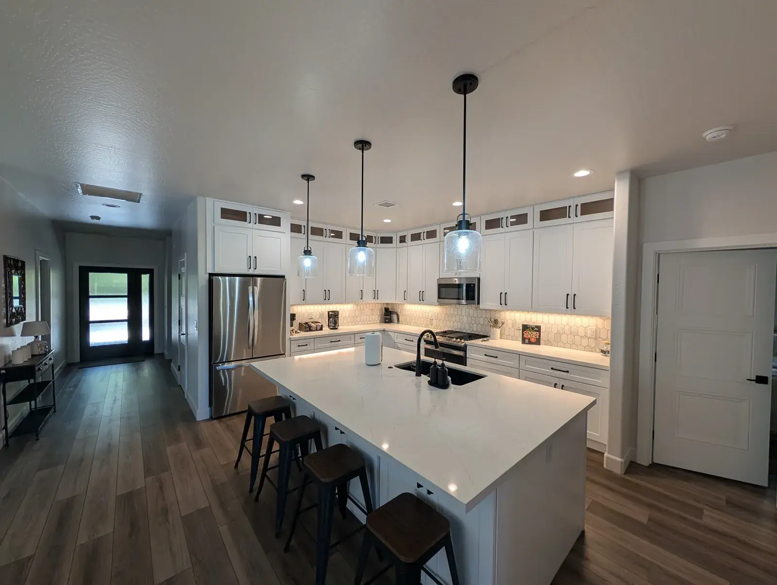 Custom kitchen with quartz island in a finished Northern Arizona home by Carlson Construction