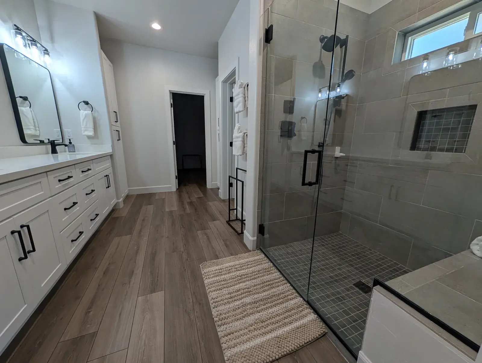 Primary bathroom with walk-in glass shower and double vanity